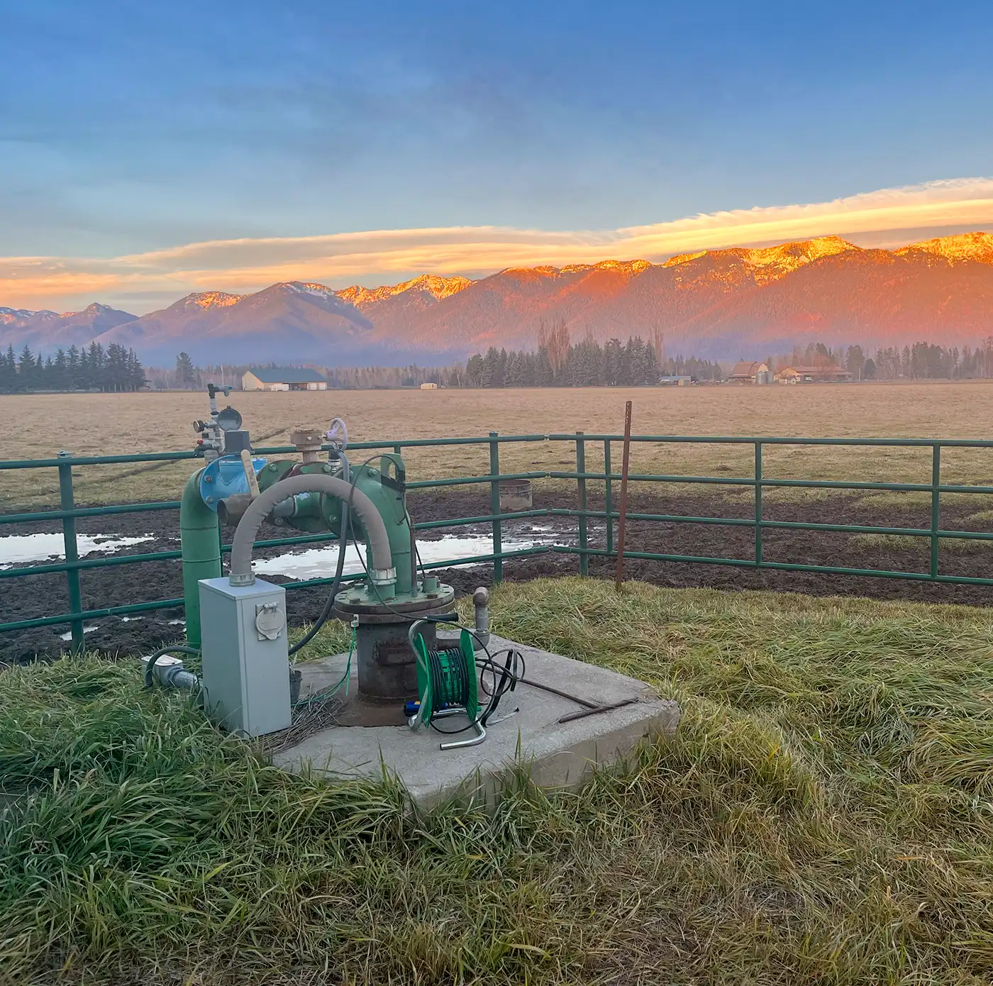 Water Rights 6 Flood control and water management equipment in a scenic rural landscape with mountains.
